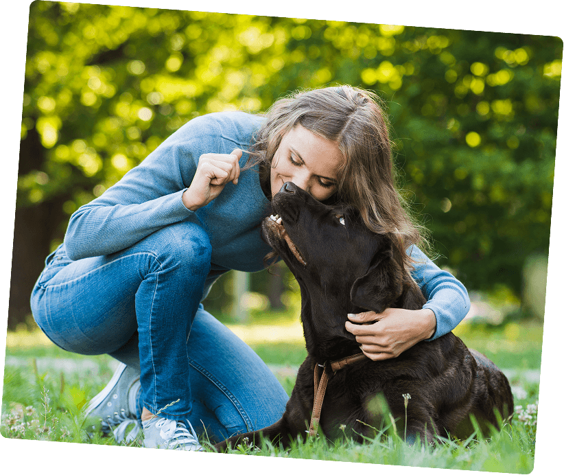 Woman cuddling her dog